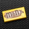 The Brick Show Shop M&N's (Peanut) - B3 Customs® Printed 1x2 Tile made using LEGO part