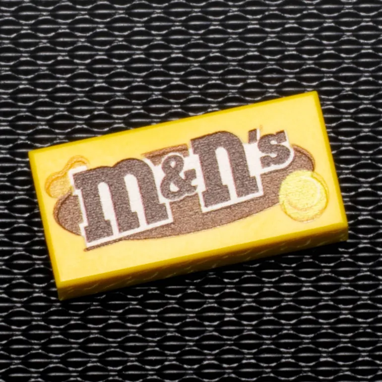 The Brick Show Shop M&N's (Peanut) - B3 Customs® Printed 1x2 Tile made using LEGO part